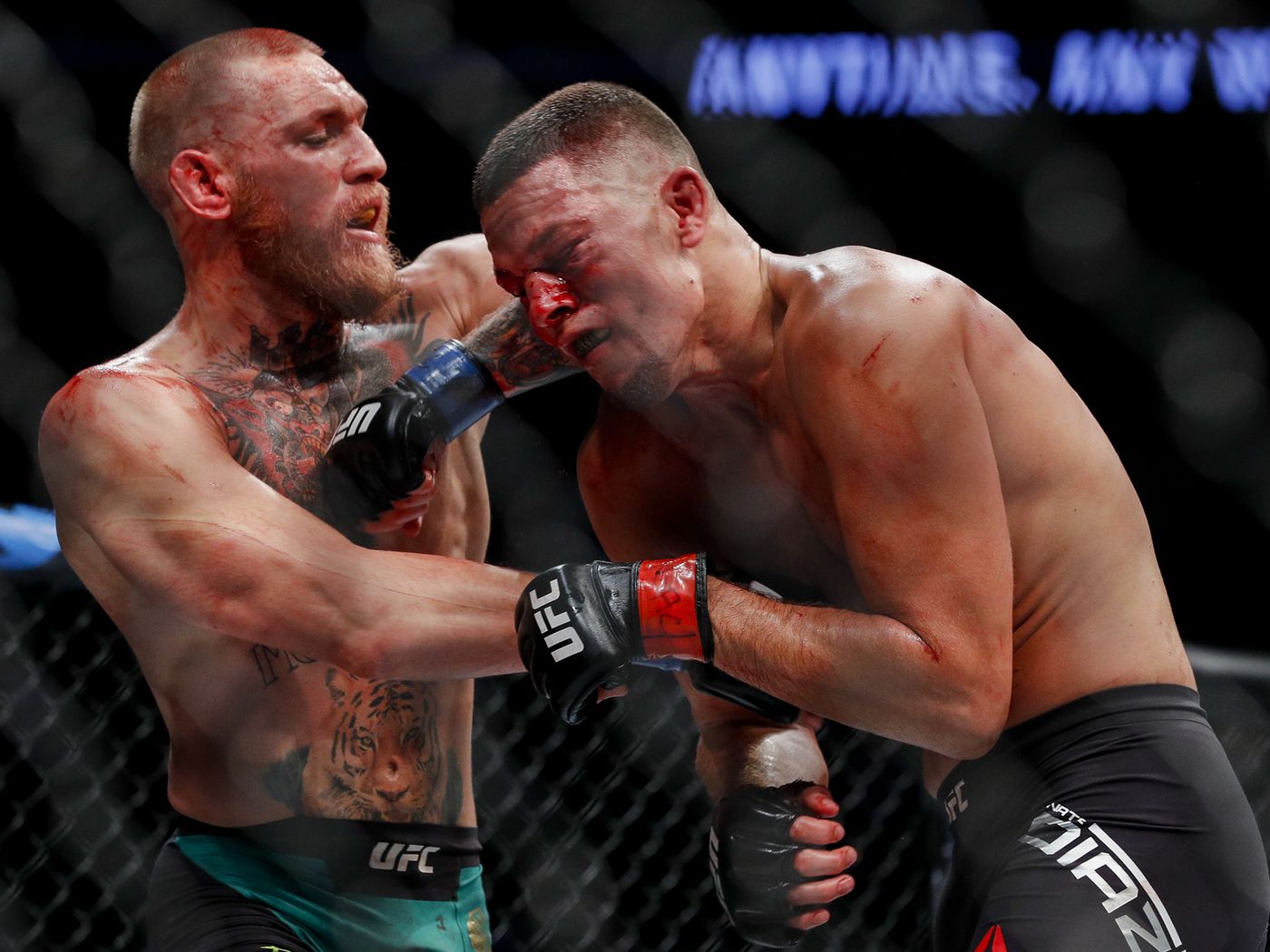 Conor McGregor throwing an elbow at Nate Diaz
