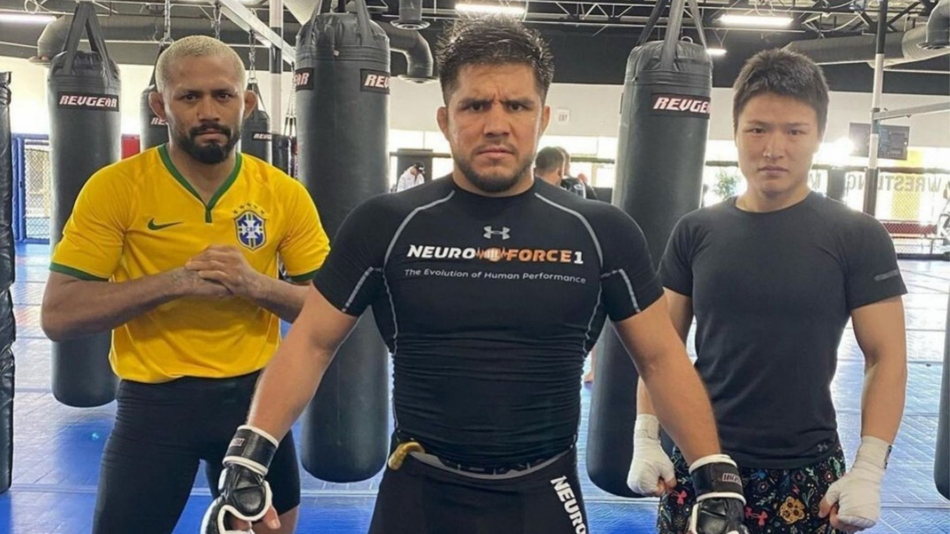 Henry Cejudo with Deiveson Figueiredo and Zhang Weili